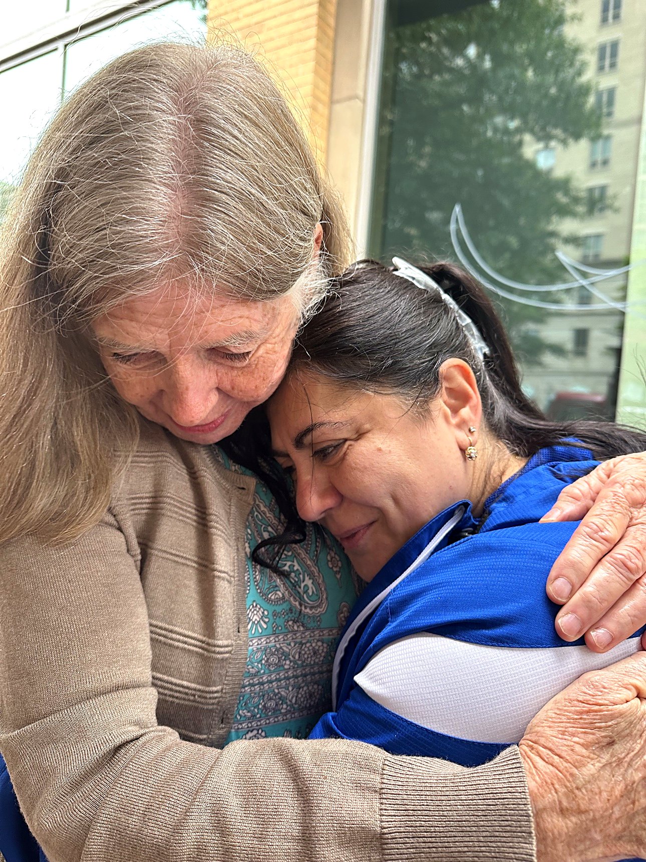 Two women holding each other by the coffee cart — a moment Isa is proud of